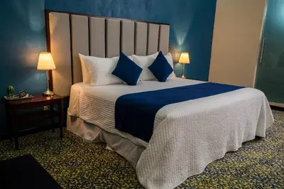 Cama o camas de una habitación en HOTEL MARGARITA