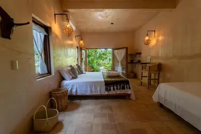 Cama o camas de una habitación en Casa Mariposa Beach Hotel