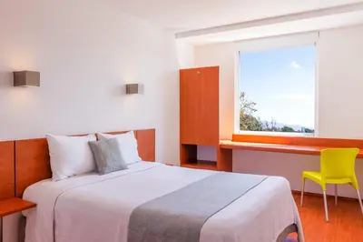 Cama o camas de una habitación en One Oaxaca Centro