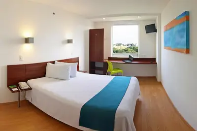 Cama o camas de una habitación en One Xalapa Las Animas