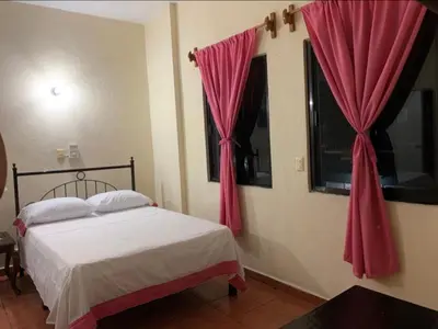 Cama o camas de una habitación en Hotel Jacaranda