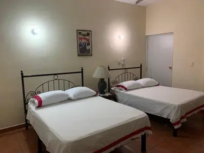 Cama o camas de una habitación en Hotel Jacaranda