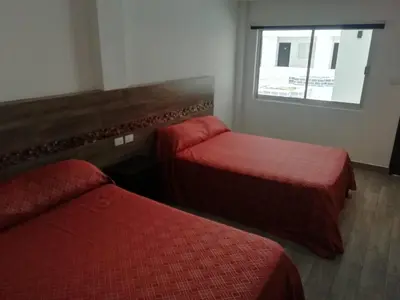 Cama o camas de una habitación en HOTEL QUINTERO