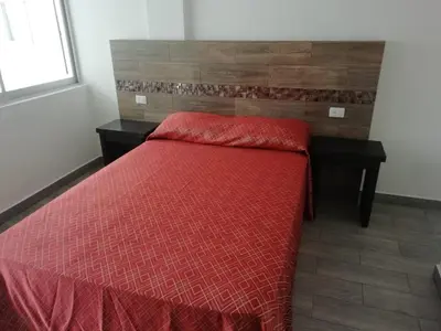 Cama o camas de una habitación en HOTEL QUINTERO