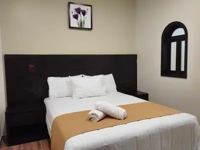 Cama o camas de una habitación en Hotel & Cabañas Malinche
