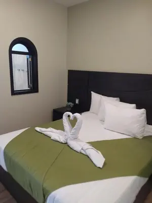 Cama o camas de una habitación en Hotel & Cabañas Malinche