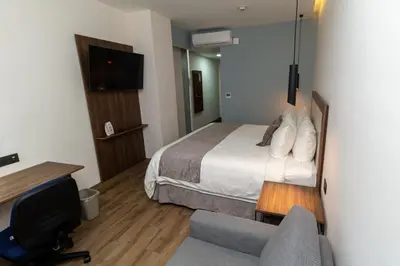 Cama o camas de una habitación en Hoteles Piedra Alta by De Los Perez