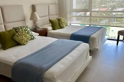 Cama o camas de una habitación en Isla Residences, frente al mar.
