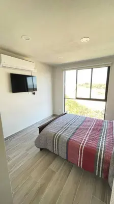 Cama o camas de una habitación en nuevo cómodo y amplio departamento 2 albercas