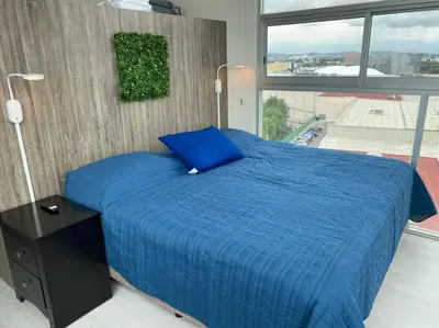 Cama o camas de una habitación en Penthouse in front of Estrella de Puebla 16 guest
