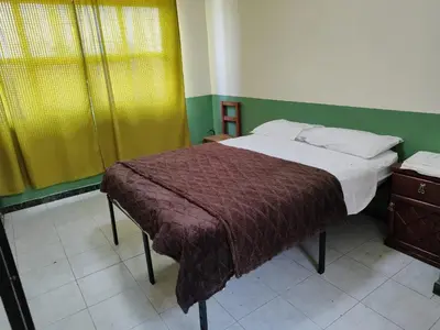 Cama o camas de una habitación en Departamentos del Jardín de Toribio