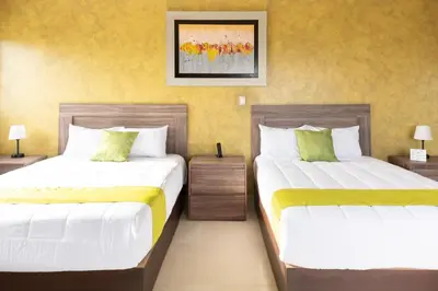 Cama o camas de una habitación en Hotel Quinta Los Laureles