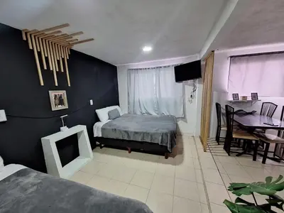 Cama o camas de una habitación en Hermoso Loft a 15min AICM