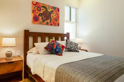 Cama o camas de una habitación en Playa Sur Paradise - Beachfront Living