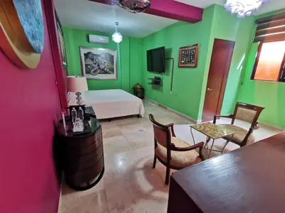 Una televisión o centro de entretenimiento en Hotel Arcadia