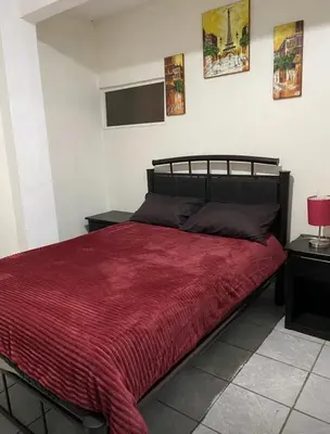 Cama o camas de una habitación en Departamento con terraza verde