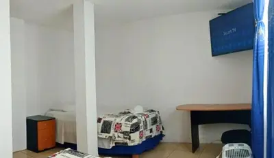 Una televisión o centro de entretenimiento en Lago24 Habitaciones