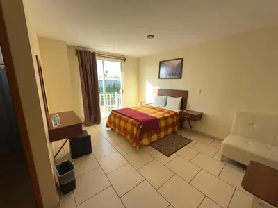Cama o camas de una habitación en Hotel Ciprés Puebla