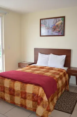 Cama o camas de una habitación en Hotel Ciprés Puebla
