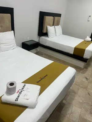 Cama o camas de una habitación en Hotel Sharidia Inn