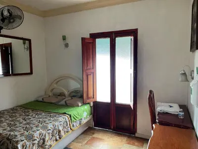 Cama o camas de una habitación en Hotel Las Flores