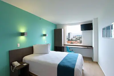 Cama o camas de una habitación en One Periferico Sur