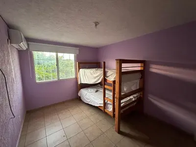 Cama o camas de una habitación en Casa en Acapulco los tulipanes