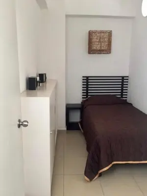 Cama o camas de una habitación en Departamento frente a la playa