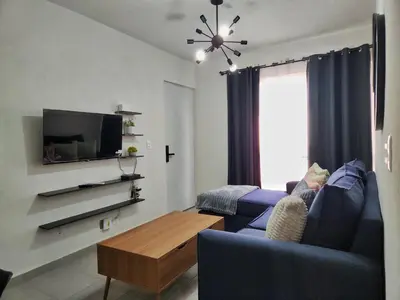 Una televisión o centro de entretenimiento en Departamento con alberca en área exclusiva Acapulco
