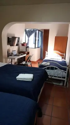 Cama o camas de una habitación en UNIVERSIDAD LATINA GUEST HOUSE CASA DE HUESPEDES a