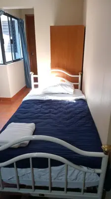 Cama o camas de una habitación en UNIVERSIDAD LATINA GUEST HOUSE CASA DE HUESPEDES a