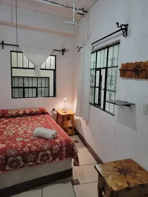 Cama o camas de una habitación en Hotel Suites Taxco