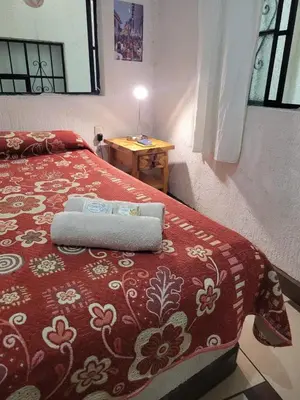 Cama o camas de una habitación en Hotel Suites Taxco