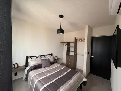 Cama o camas de una habitación en Departamento en Acapulco Diamante