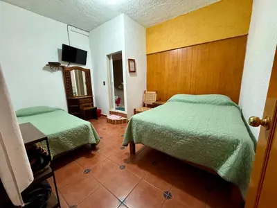 Cama o camas de una habitación en Hospedaje Teponaztle