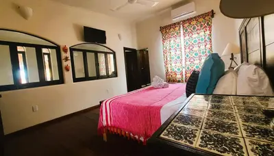 Cama o camas de una habitación en Casa Rosa Paradise