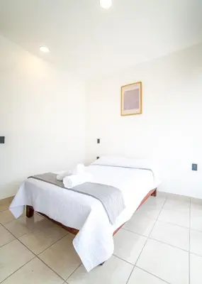 Cama o camas de una habitación en Hotel Catedral Jojutla