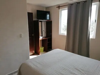 Cama o camas de una habitación en Hospedaje Migue y Cata y Centro Holístico Kuatlicue