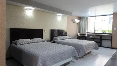 Cama o camas de una habitación en Hotel Montecarlo Jojutla