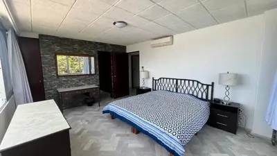Cama o camas de una habitación en Departamento con vista al mar y campo de Golf
