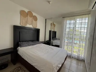 Cama o camas de una habitación en CASALUNA frente alberca AirAc