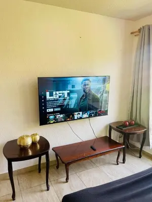 Una televisión o centro de entretenimiento en Casa Azul de descanso, alberca, billar, asador y roof garden privado