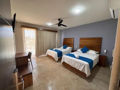 Cama o camas de una habitación en Aeropuerto Express Huatulco