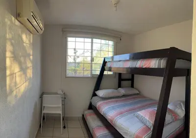 Cama o camas de una habitación en Departamento planta baja en la laguna