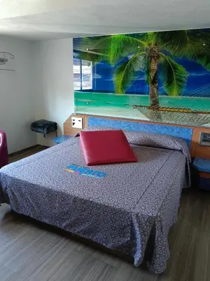 Cama o camas de una habitación en Hotel Puerto Angel