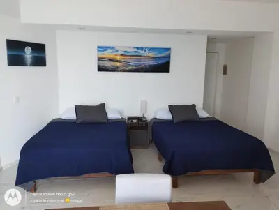 Cama o camas de una habitación en Suite Frontal a Pie de Playa con Terraza Panorámica