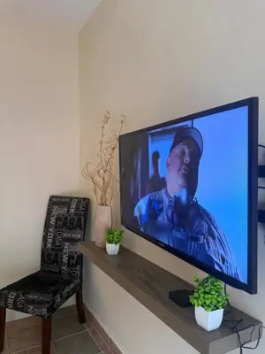 Una televisión o centro de entretenimiento en 1 Centrico y lujoso apartamento en Atlíxco