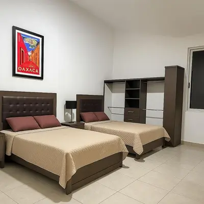 Cama o camas de una habitación en Recámaras en Oaxaca con servicio de chófer