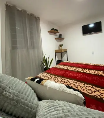 Una televisión o centro de entretenimiento en Habitaciones estadios maravillas