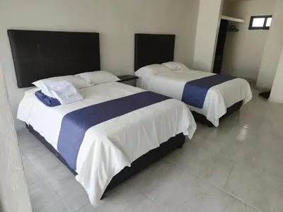 Cama o camas de una habitación en Oasis Hotel Jojutla